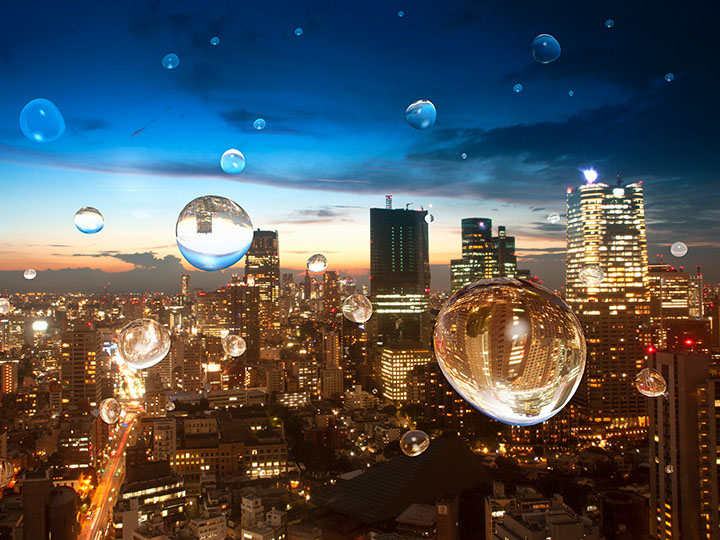 Water drops on a window overlooking a cityscape at sunset
