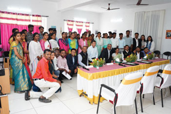 Group of people posing for photo inside community center